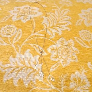 Tiffany & Co., silver T & Co. lariat necklace.